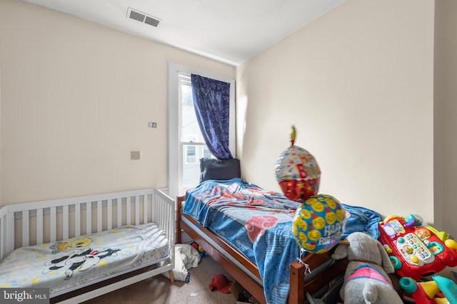 bedroom with carpet floors and lofted ceiling