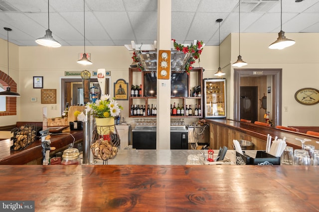 kitchen with hanging light fixtures and a paneled ceiling