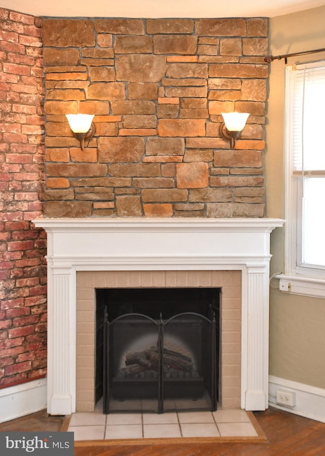 room details featuring hardwood / wood-style flooring and a stone fireplace