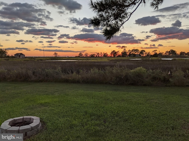 yard at dusk with an outdoor fire pit