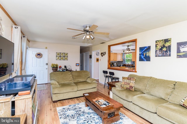 living room featuring light wood-type flooring and ceiling fan