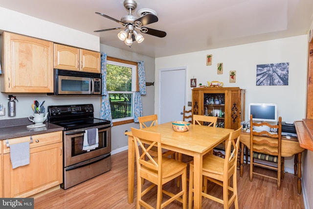 kitchen with ceiling fan, light brown cabinets, stainless steel appliances, and light hardwood / wood-style flooring