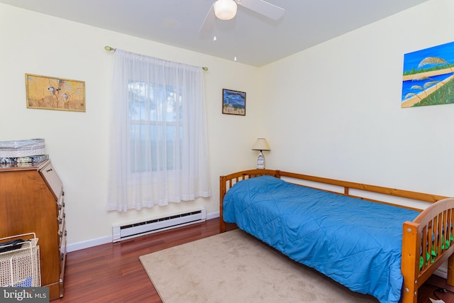 bedroom with ceiling fan, a baseboard radiator, and dark hardwood / wood-style floors