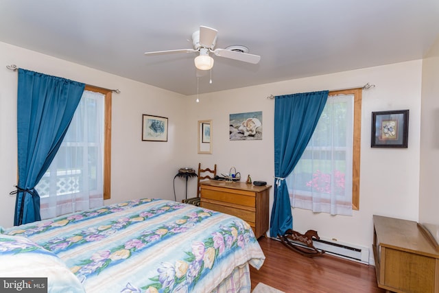 bedroom featuring ceiling fan, dark wood-type flooring, and a baseboard radiator