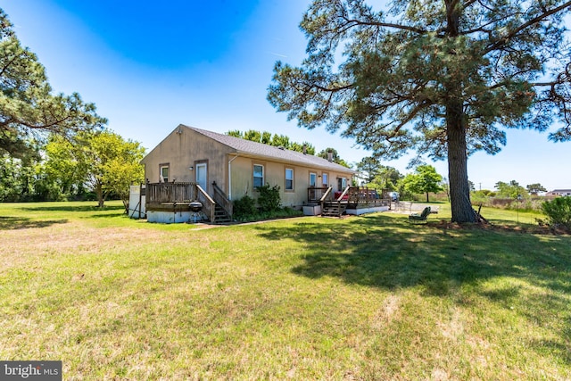 exterior space featuring a deck and a lawn