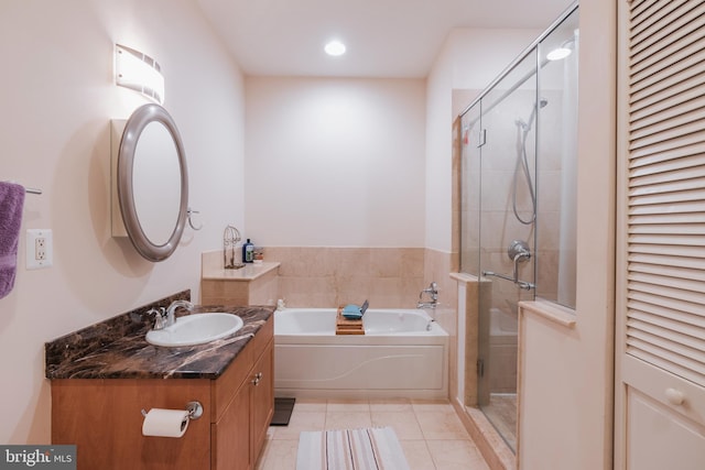 bathroom with vanity, tile patterned floors, and plus walk in shower