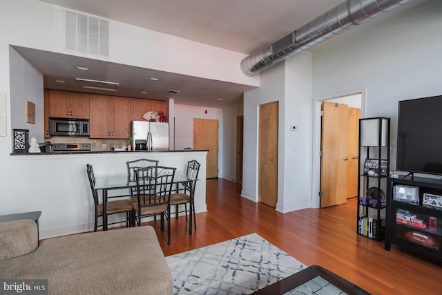 dining room with hardwood / wood-style flooring