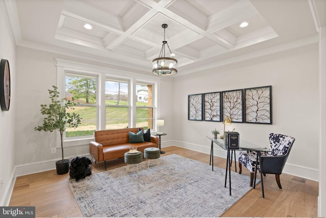 sitting room with beamed ceiling, coffered ceiling, a notable chandelier, light hardwood / wood-style floors, and crown molding