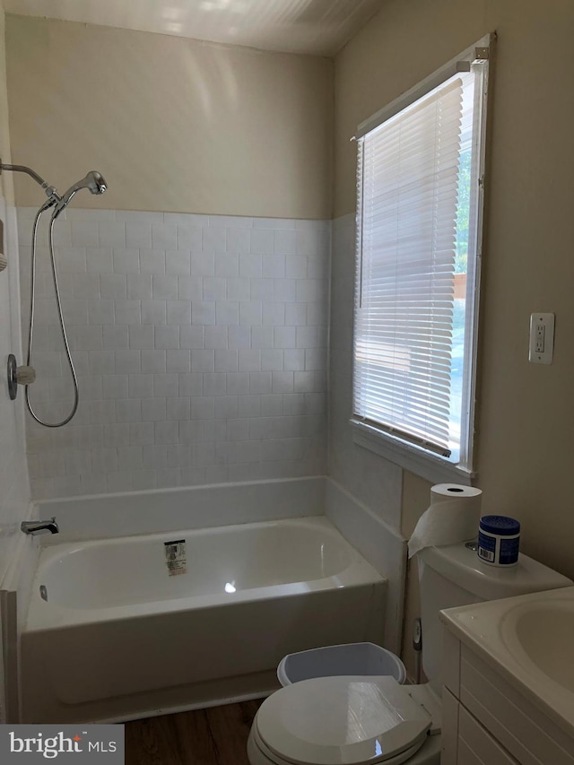 full bathroom with plenty of natural light, wood-type flooring, vanity, and toilet