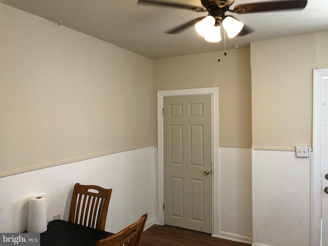 bedroom with dark hardwood / wood-style flooring and ceiling fan