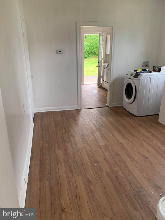 washroom featuring hardwood / wood-style flooring and washer / dryer