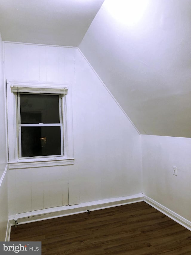 bonus room featuring lofted ceiling and dark hardwood / wood-style flooring