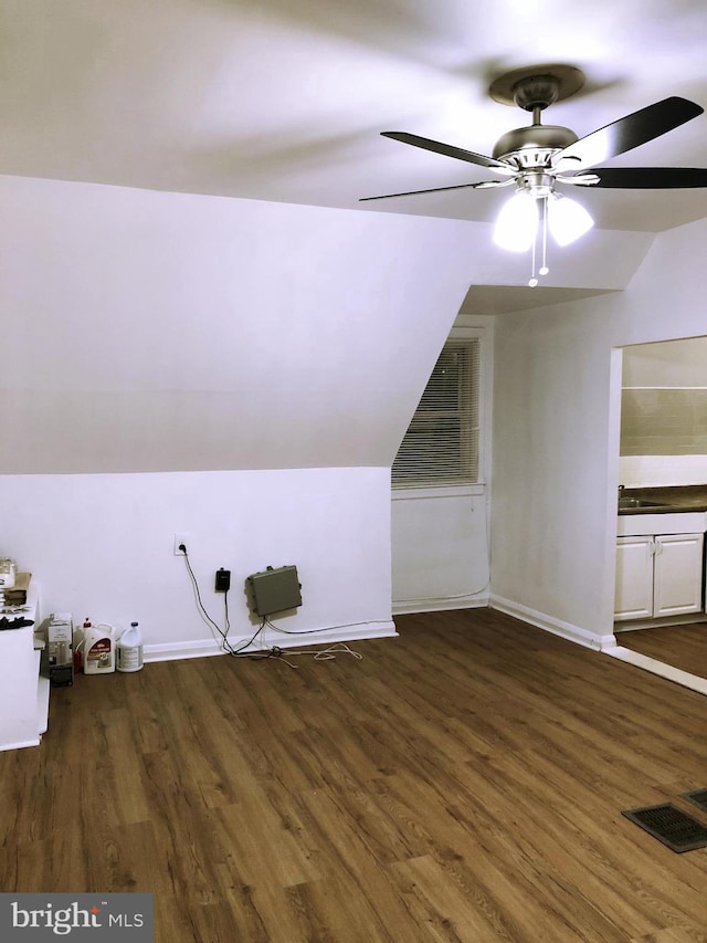 additional living space featuring vaulted ceiling, ceiling fan, and dark hardwood / wood-style floors