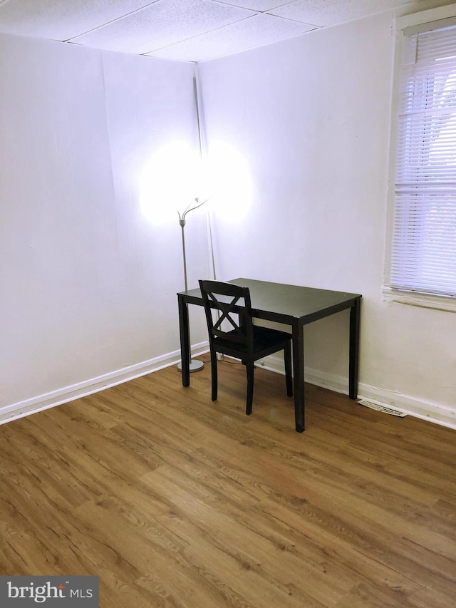 unfurnished office with hardwood / wood-style flooring and a textured ceiling