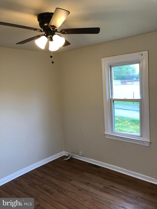 spare room featuring ceiling fan and dark hardwood / wood-style floors