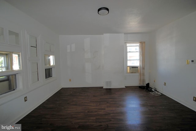 spare room with dark wood-type flooring