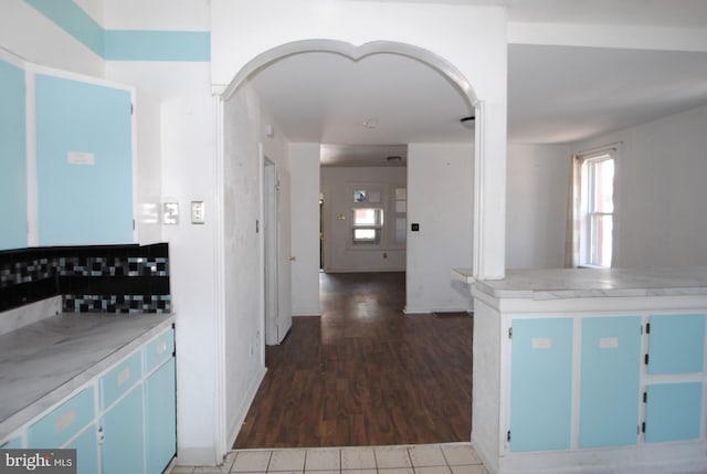 kitchen featuring blue cabinets and dark hardwood / wood-style floors