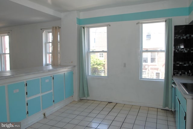 kitchen with light tile patterned flooring