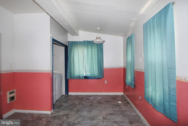 spare room featuring lofted ceiling, washer and clothes dryer, and heating unit