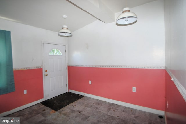 entrance foyer featuring beamed ceiling