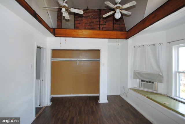 unfurnished bedroom featuring ceiling fan, dark wood-type flooring, multiple windows, and high vaulted ceiling