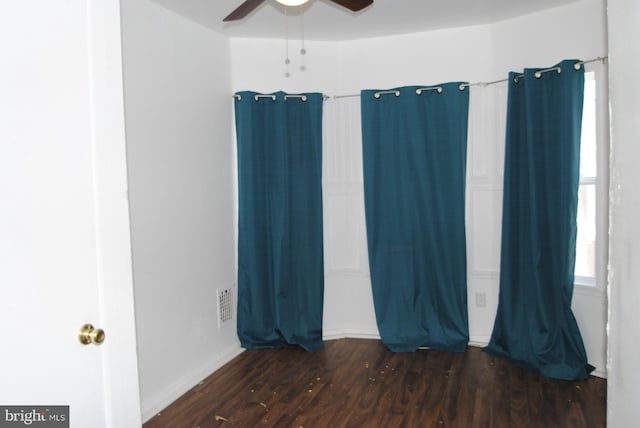 unfurnished room with dark wood-type flooring and ceiling fan