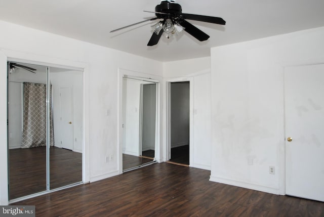 unfurnished bedroom with dark hardwood / wood-style flooring and ceiling fan