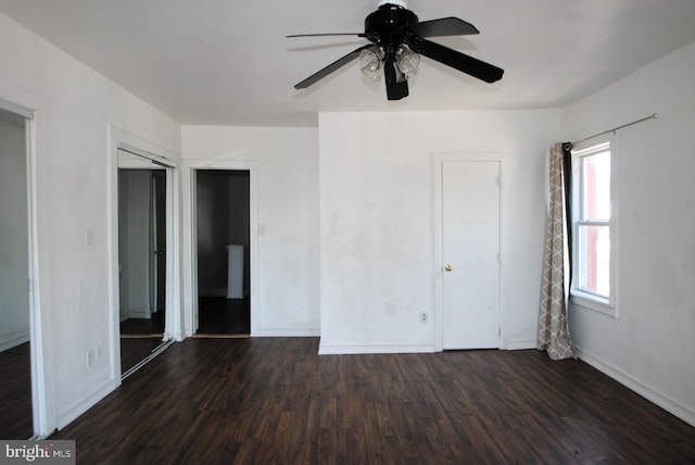 unfurnished bedroom with ceiling fan and dark hardwood / wood-style floors