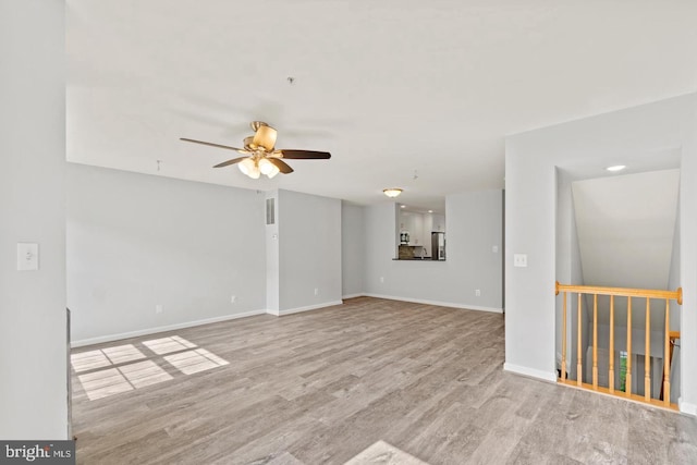 unfurnished room featuring ceiling fan and light wood-type flooring