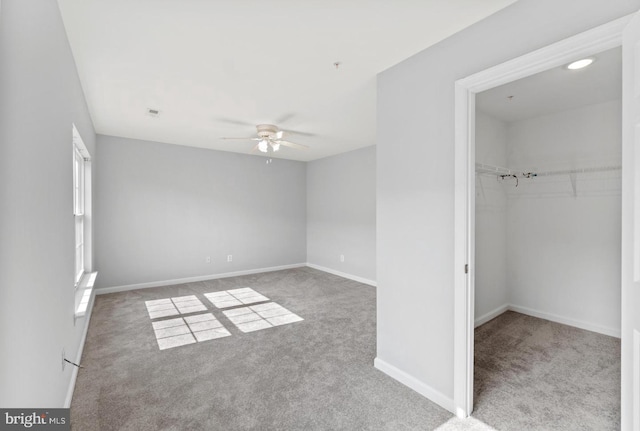 unfurnished bedroom featuring a closet, light carpet, and ceiling fan