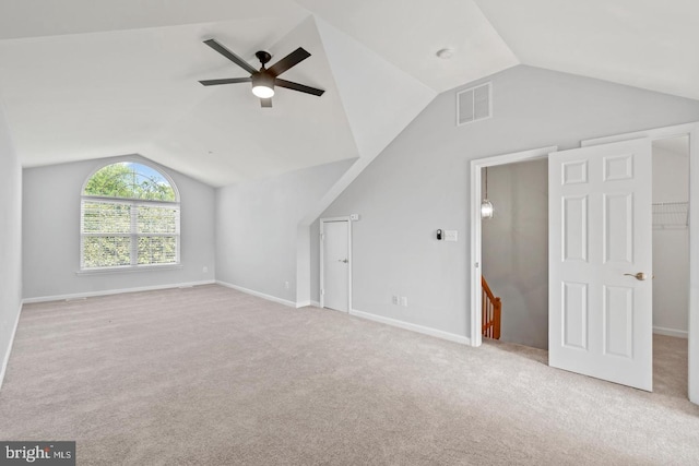 additional living space featuring light carpet, ceiling fan, and vaulted ceiling