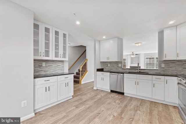 kitchen featuring light hardwood / wood-style flooring, sink, stainless steel appliances, and tasteful backsplash