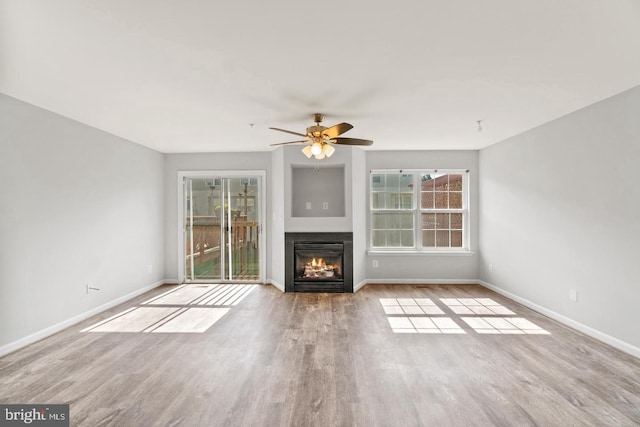 unfurnished living room featuring light hardwood / wood-style flooring and ceiling fan