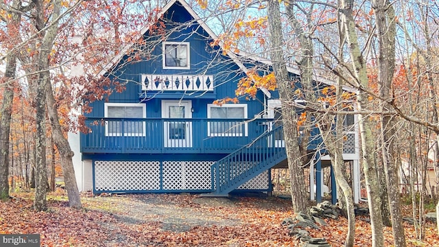 back of house with a wooden deck