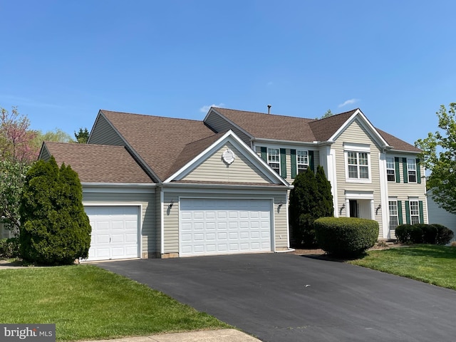 view of front facade with a garage and a front yard