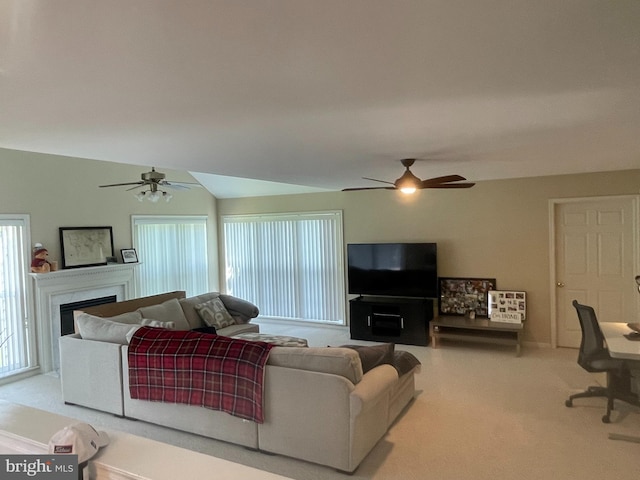 living room with ceiling fan and carpet