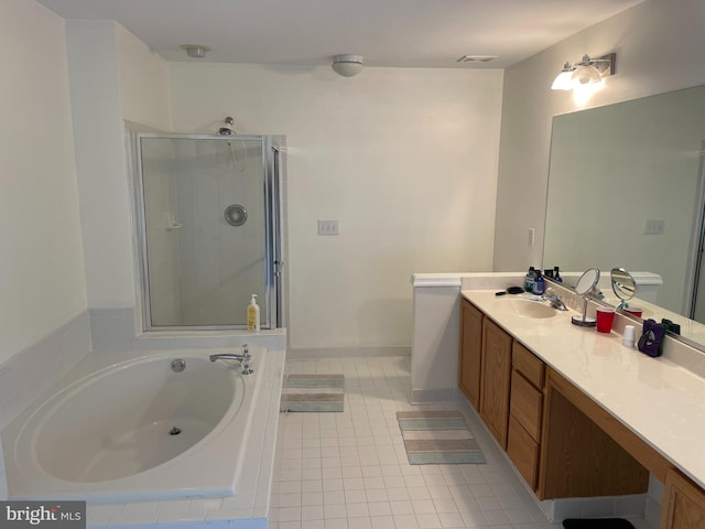 bathroom with vanity with extensive cabinet space, tile flooring, and independent shower and bath