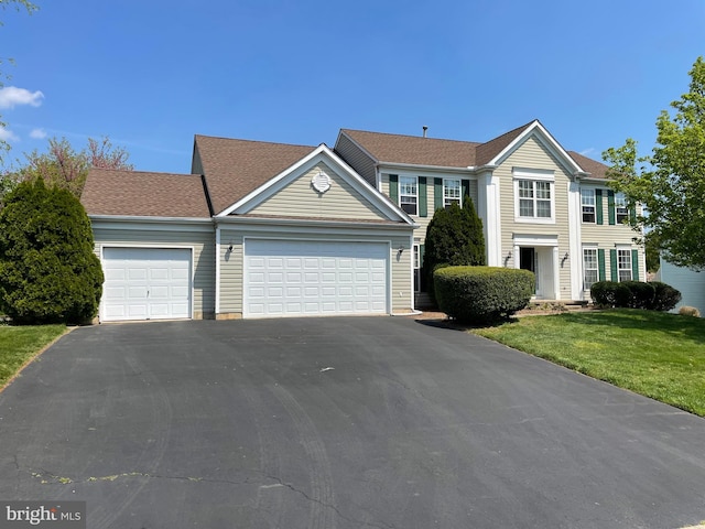 view of front facade with a front lawn and a garage