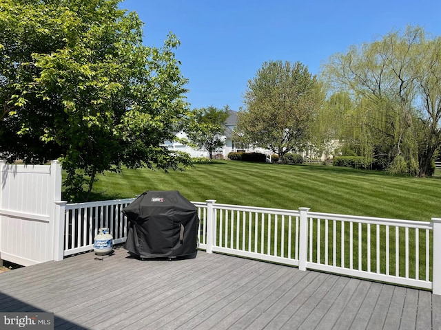 wooden terrace featuring a yard