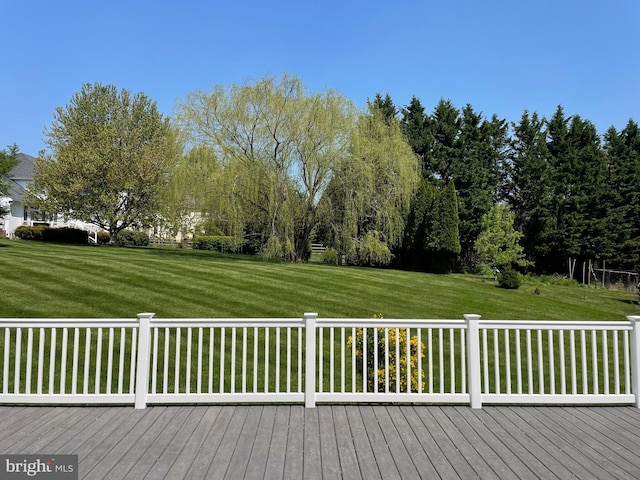 wooden terrace featuring a lawn