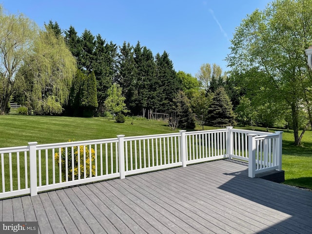 wooden terrace featuring a yard