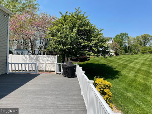 wooden terrace featuring a yard