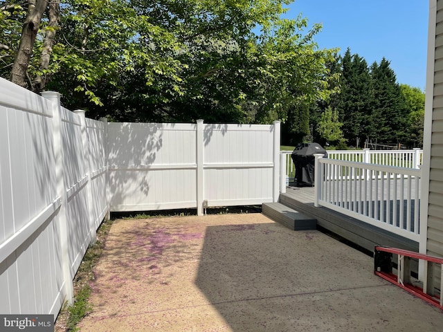 view of yard with a patio area and a wooden deck