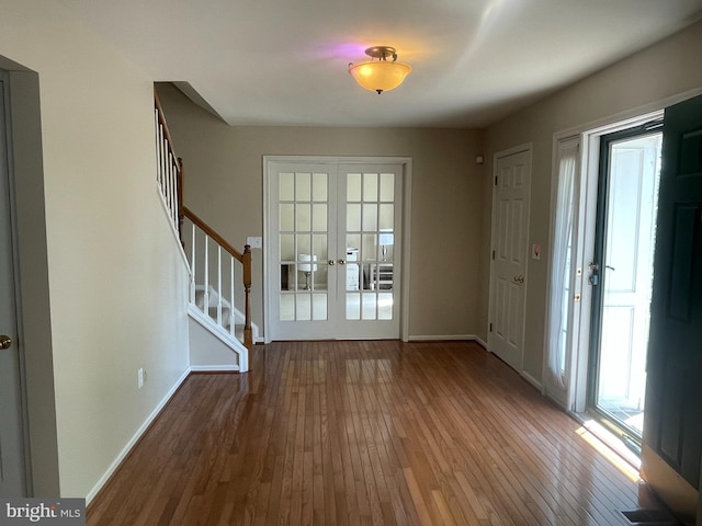 entryway with french doors and dark wood-type flooring