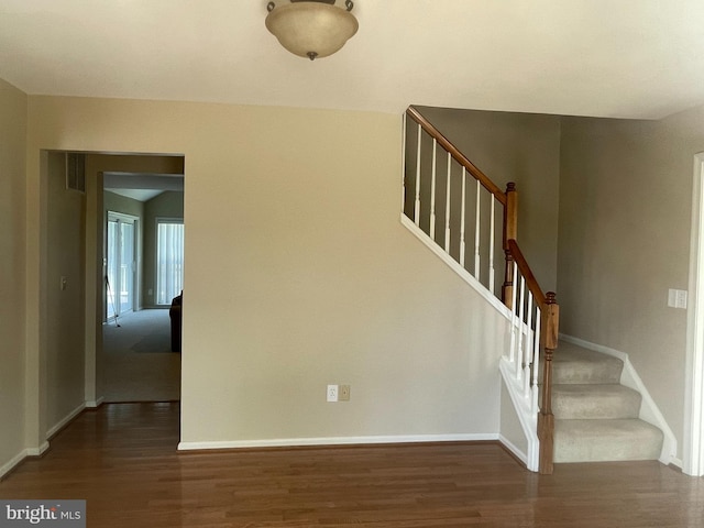 staircase featuring dark wood-type flooring