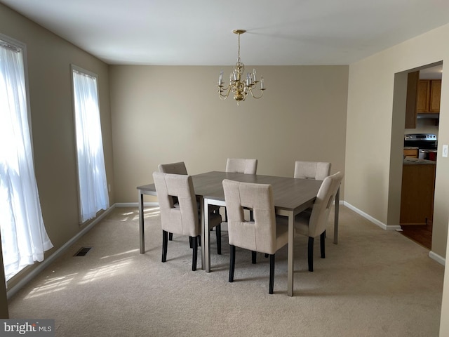 carpeted dining space with a notable chandelier and a healthy amount of sunlight