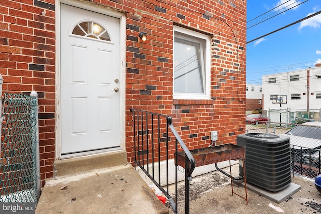 property entrance featuring central AC unit