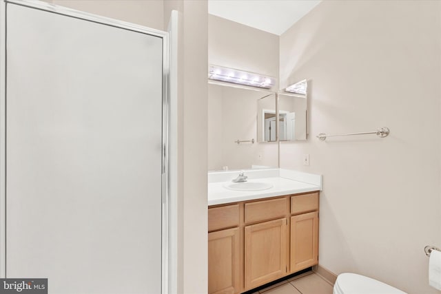 bathroom featuring tile flooring, vanity with extensive cabinet space, an enclosed shower, and toilet