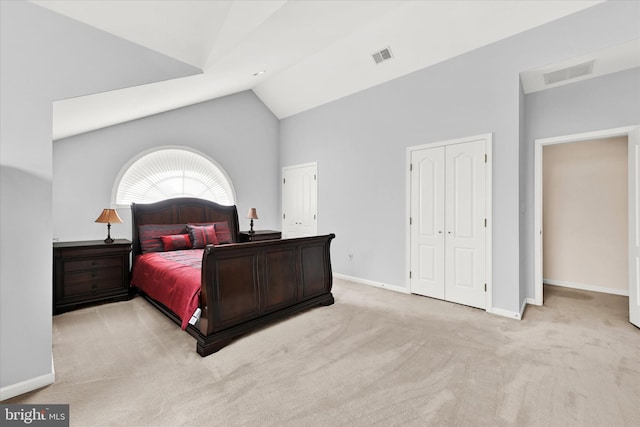 bedroom featuring light colored carpet and vaulted ceiling