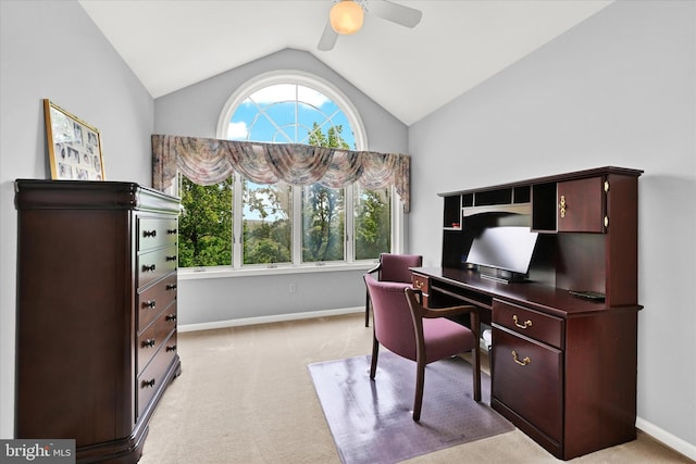 carpeted home office with ceiling fan and vaulted ceiling